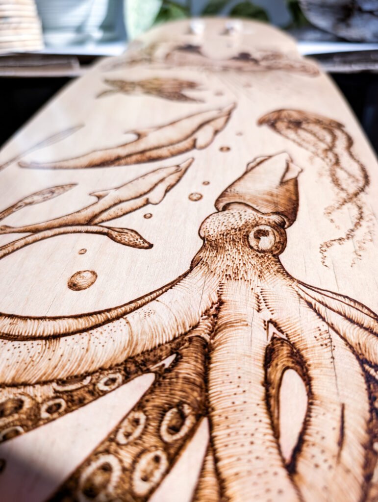 Closeup of wood burned longboard